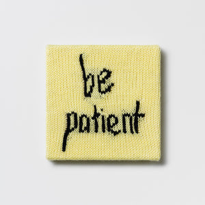 Kate Just, Rule #17: Be Patient, 2024, hand knitted acrylic yarn, canvas, and timber, 21 x 21 cm