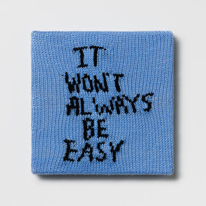 Kate Just, Rule #21: It Won't Always Be Easy, 2024, hand knitted acrylic yarn, canvas, and timber, 26 x 26 cm