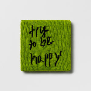 Kate Just, Rule #30: Try to Be Happy, 2024, hand knitted acrylic yarn, canvas, and timber, 21 x 21 cm