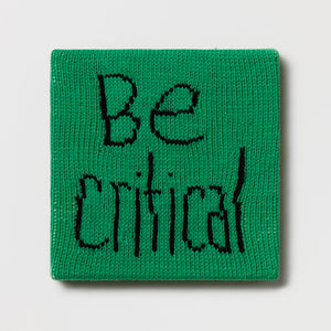 Kate Just, Rule #35: Be Critical, 2024, hand knitted acrylic yarn, canvas, and timber, 26 x 26 cm