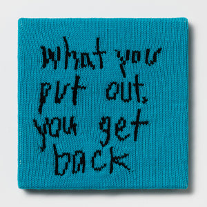 Kate Just, Rule #36: What You Put Out, You Get Back, 2024, hand knitted acrylic yarn, canvas, and timber, 31 x 31 cm