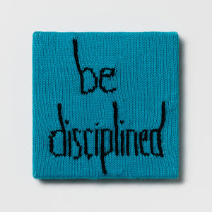 Kate Just, Rule #42: Be Disciplined, 2024, hand knitted acrylic yarn, canvas, and timber, 26 x 26 cm