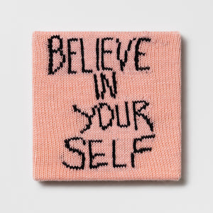 Kate Just, Rule #45: Believe in Yourself, 2024, hand knitted acrylic yarn, canvas, and timber, 26 x 26 cm