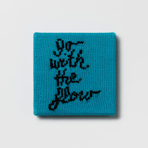 Rule #47: Go with the Flow, 2024, hand knitted acrylic yarn, canvas, and timber, 21 x 21 cm