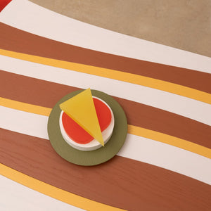 Daniel Emma, Blanket Table - Red (detail), 2025, resin, timber veneer plywood, and paint, 28 x 92 x 45 cm; Daniel Emma, Beach Stack (on plate), 2025, resin, solid timber, and paint, 9 x 15 x 15 cm