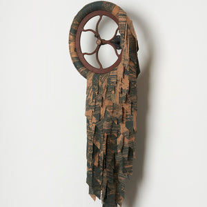 Julia Robinson, Bruising the green, 2024, linen, thread, bleach, foam, wheel, steel, fixings, 110 x 45 x 15 cm