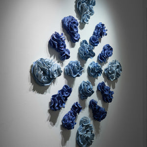 Sam Gold, The marrow in the tide, slowly spills into the mouth of love (installation view, Hugo Michell Gallery), 2024, porcelain and glaze, 185 x 170 x 18 cm irreg.