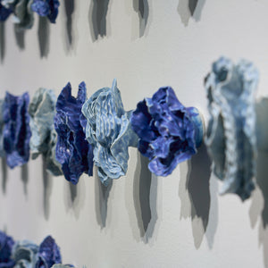 Sam Gold, The restless tension between both poles and how we harmonise them into something beautiful (installation detail), 2024, porcelain and glaze, 80 x 161 x 10 cm irreg.