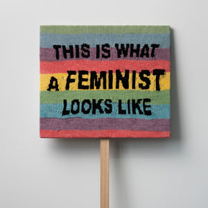 Kate Just, This Is What A Feminist Looks Like, 2021, knitted wool as placard with plywood stand, 50 x 58 cm