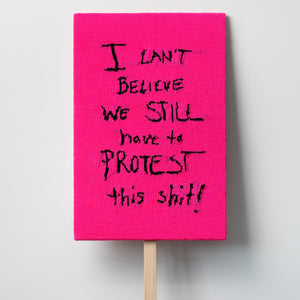 Kate Just, I Can’t Believe We Still Have to Protest This Shit, 2021, knitted wool as placard with plywood stand, 72 x 48 cm