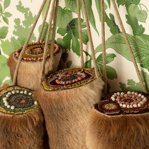 Sera Waters, 2014, Stumped: A family gathering (detail), Four kangaroo tails, beads, cotton, linen and stuffing + found bill holder and wallpaper, variable dimensions