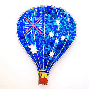 Paul Yore, Hot Air Balloon (Flag), 2025, mixed media assemblage on board comprising plastic, glass, fabric, trim, cotton thread, LED light, wood, synthetic polymer, adhesive, and fixtures, 119 x 91.5 x 9.5 cm irreg.
