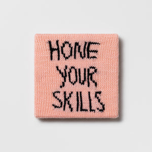 Kate Just, Rule #19: Hone Your Skills, 2024, hand knitted acrylic yarn, canvas, and timber, 21 x 21 cm