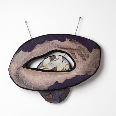 Sera Waters, Patterns of Min(e)ing: Embrace of Stone, 2025, cotton, linen, hand-dyed calico, beads, glow-in-the-dark thread, repurposed chain, stuffing, felt, approximately 32 x 34 cm (installed). Photo by Grant Hancock
