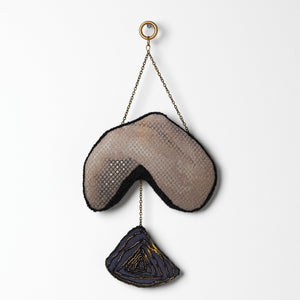 Sera Waters, Patterns of Min(e)ing: Self-made Refuge, 2025, cotton, linen, hand-dyed calico, beads, glow-in-the-dark thread, repurposed chain, stuffing, felt, approximately 26cm x 13cm (installed). Photo by Grant Hancock