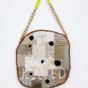 Sera Water, Vested Interests, 2025, wool on canvas, glow-in-the-wool, repurposed chain, card, fabric, 40 × 22 cm