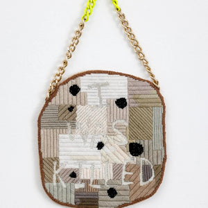 Sera Waters, Vested Interests, 2025, wool on canvas, glow-in-the-wool, repurposed chain, card, fabric, 40 x 22 cm
