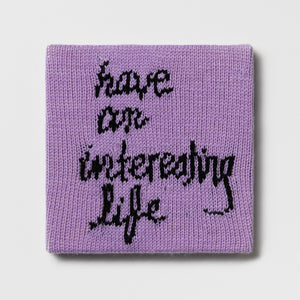 Kate Just, Rule #23: Have an Interesting Life, 2024, hand knitted acrylic yarn, canvas, and timber, 26 x 26 cm