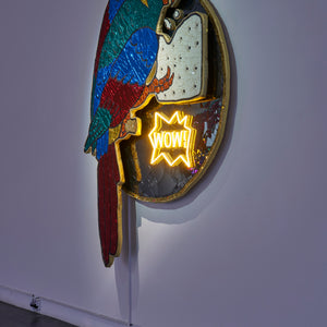 Paul Yore, Parrot (Wow) (installation view), 2025, mixed media assemblage on board comprising plastic, fabric, trim, cotton thread, LED light, wood, synthetic polymer, adhesive, and fixtures, 184 x 134 x 15.5 cm irreg.