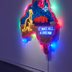 Paul Yore, Uluru (It Was All A Dream) (installation view), 2025, mixed media assemblage on board comprising glass, plastic, beads, synthetic fur, trim, cotton thread, LED light, wood, synthetic polymer, adhesive, and fixtures, 185 x 174 x 13 cm irreg.