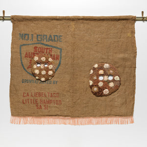 Sera Waters, Private Eye(Lets), 2022, repurposed hessian sack, hand-dyed string, cotton, trim, brass pole with ceramic and brass fittings, various nylon tapes, 96 x 130 cm