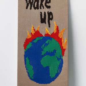 Kate Just, Wake Up, 2022, knitted wool as placard with plywood stand, 98 x 50 cm