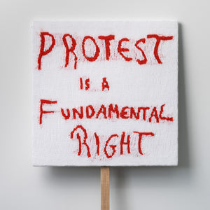 Kate Just, Protest Is A Fundamental Right, 2021, knitted wool as placard with plywood stand, 65 x 65 cm
