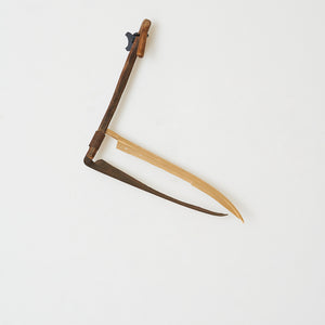 Julia Robinson, Snicker-snack, 2021, modified scythe, gold plated scythe blade, steel, 85 x 65 x 25 cm