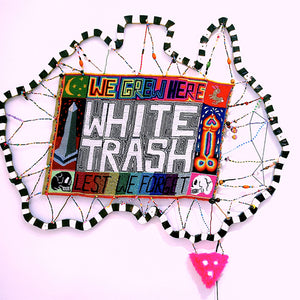  White Trash, 2013, wool needlepoint with wooden frame, found objects, dimensions variable