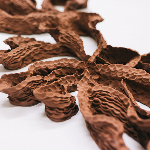 Sam Gold, Woven and Worn (detail), 2022, terracotta and hand harvested, processed local ironstone, 47 x 168 x 11 cm